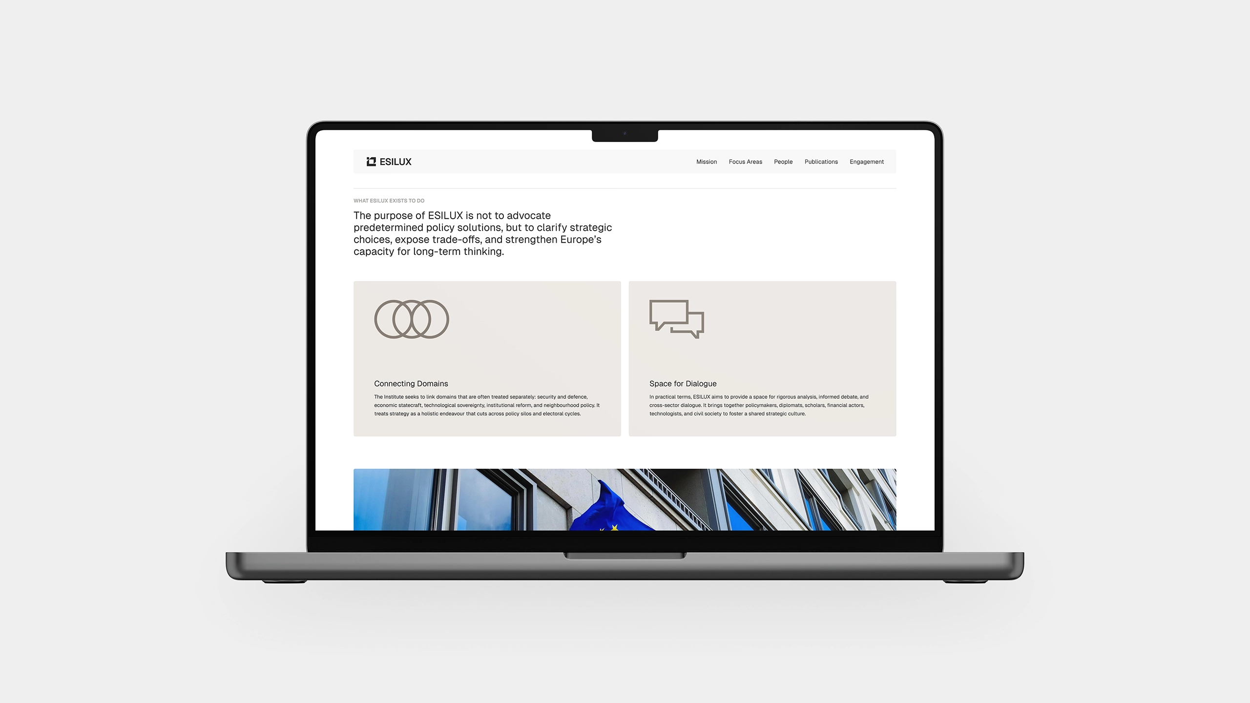 ESILUX website mission page displayed on MacBook, showing Connecting Domains and Space for Dialogue sections with European Union flag imagery