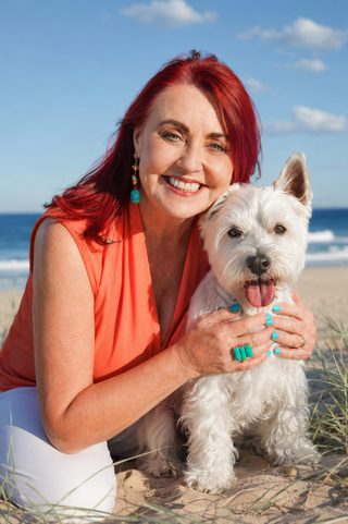 Marion McDonald with her dog Kenji on the beach