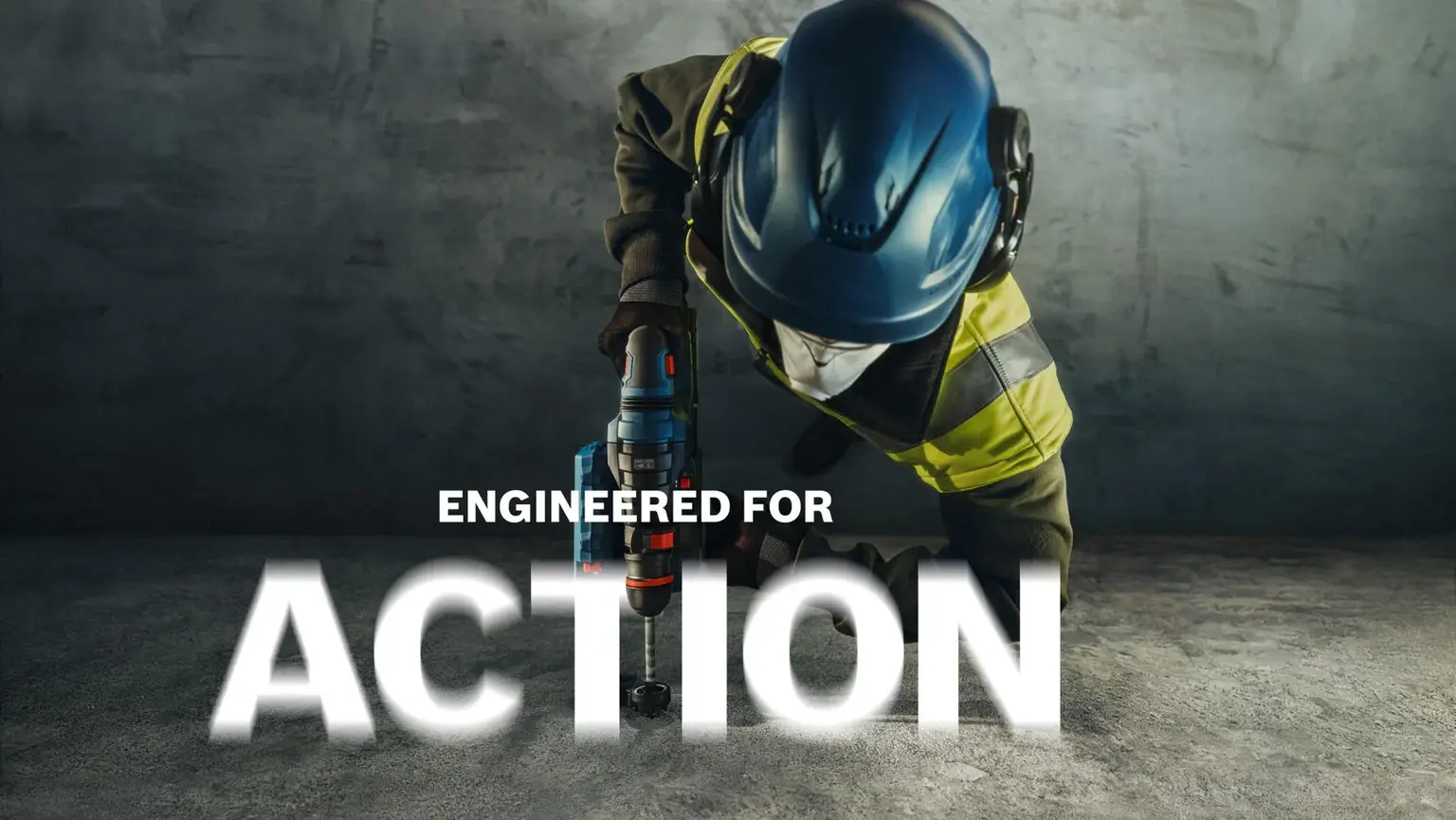 Arbeiter mit blauem Schutzhelm und Warnweste bohrt mit Akku-Bohrmaschine. Slogan: „Engineered for Action".