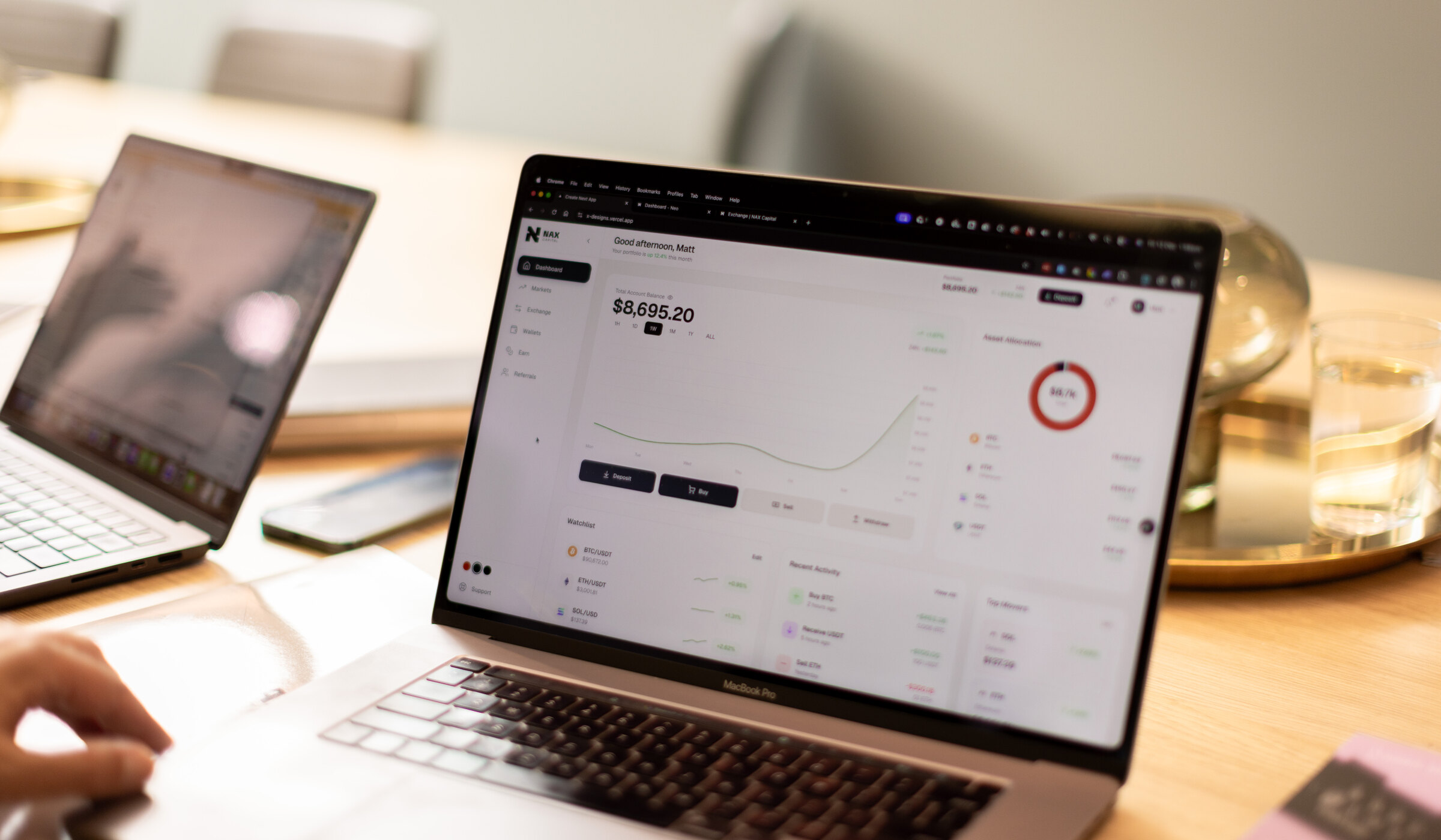 NAX investment dashboard on laptop
