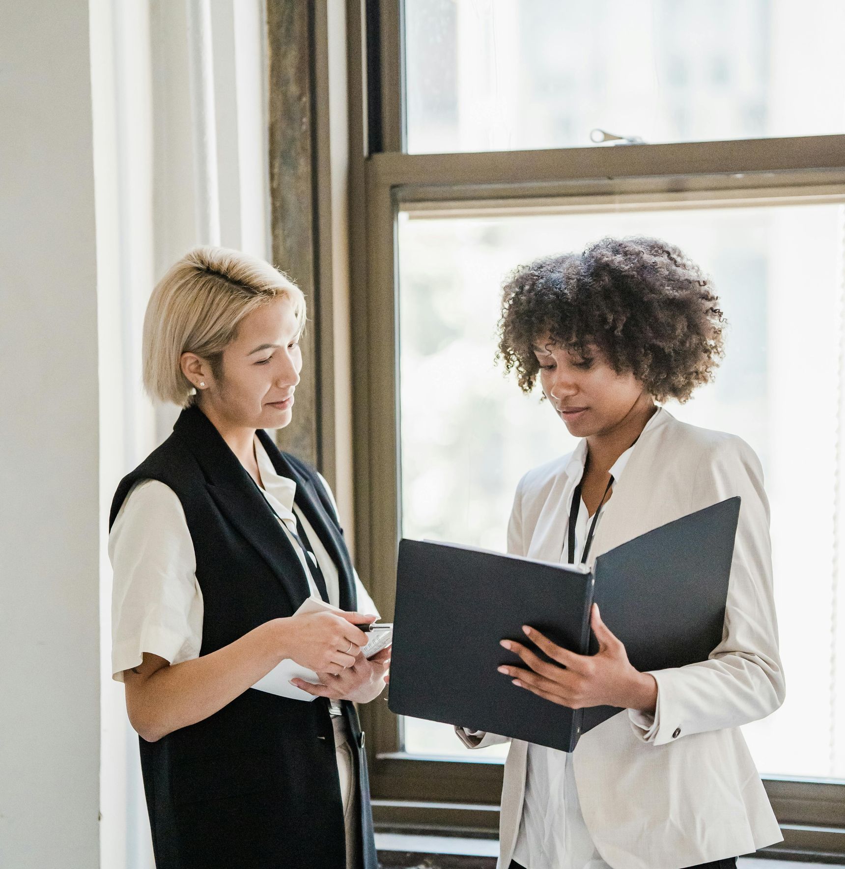 Two HR consultants reviewing workforce analytics and HR data to drive people-focused insights.