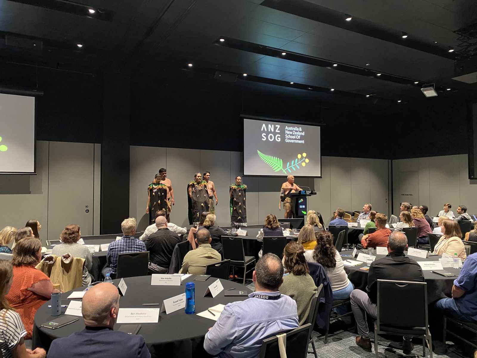 Māori cultural performers welcoming Executive Master of Public Administration students in a conference room in Christchurch