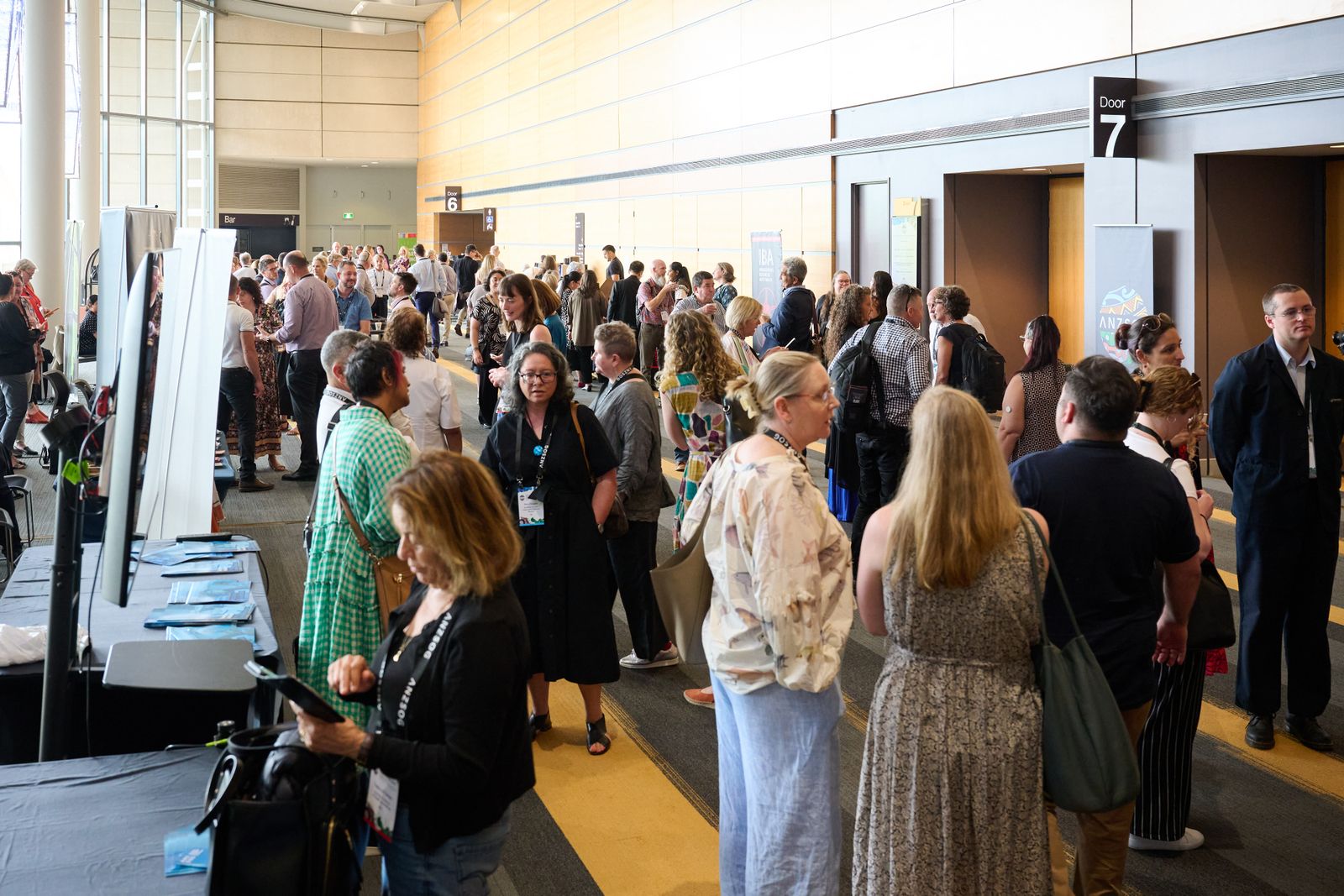 Crowd of delegates mingling in the foyer of the conference centre