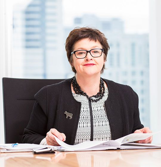 Keryn Negri seated at a desk with documents
