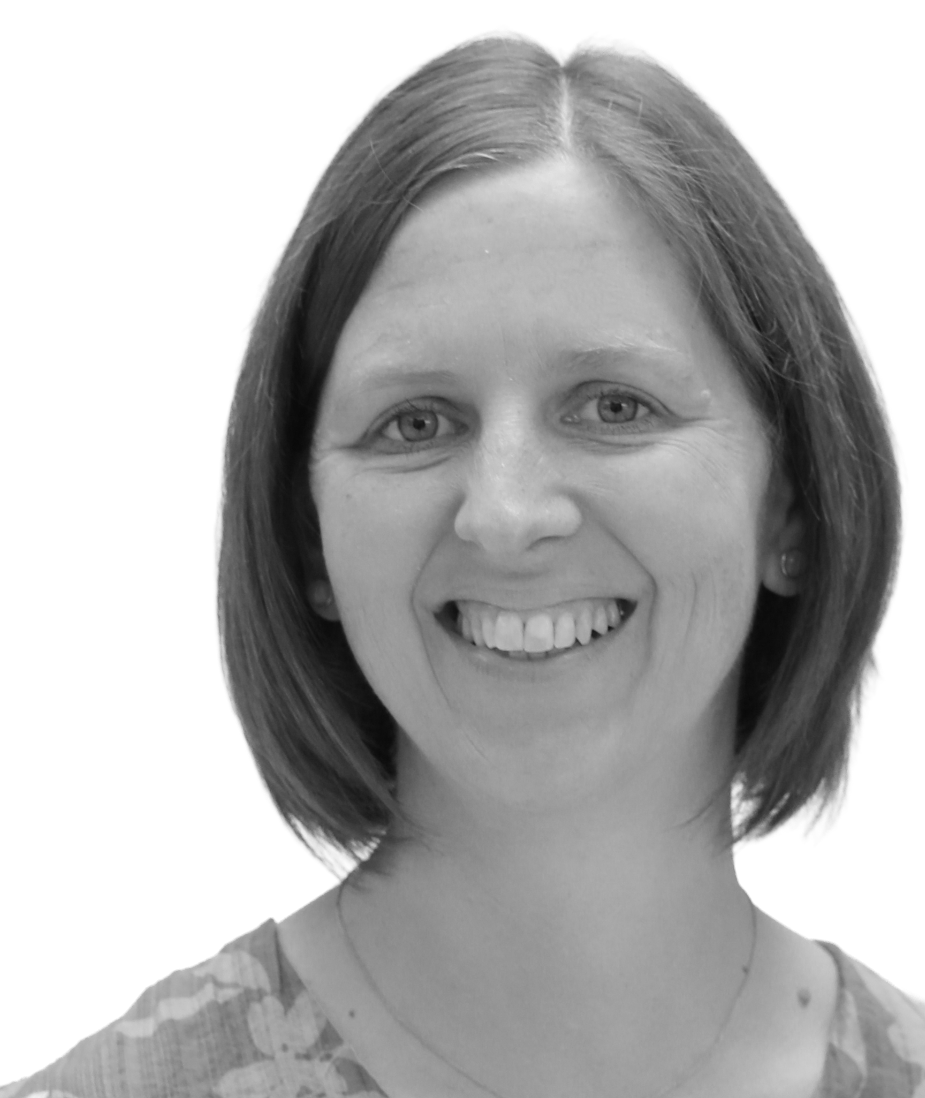 Smiling woman with short hair, wearing a patterned top, in a black and white photo.