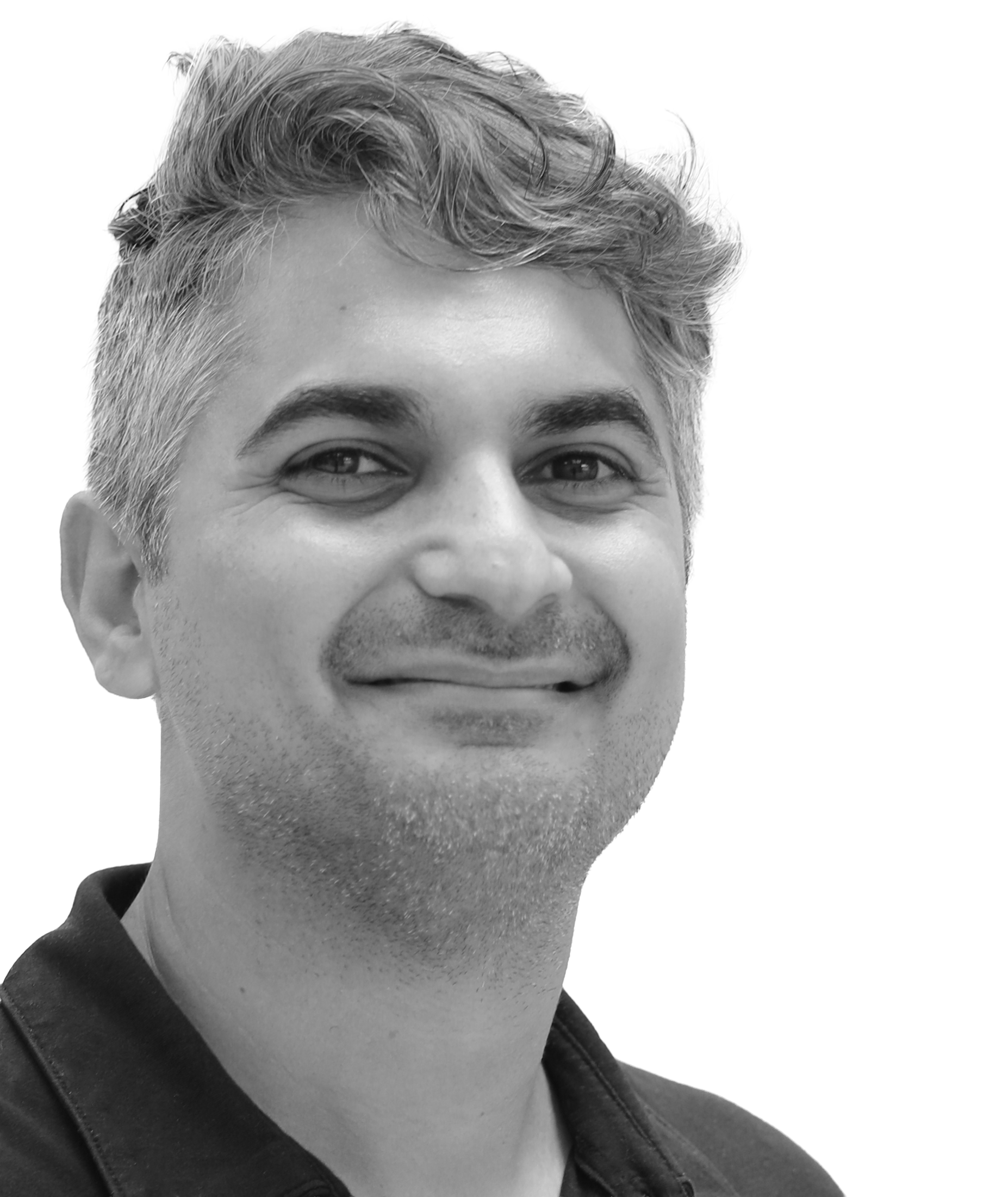 Smiling man with short wavy hair and light stubble in a black shirt against a white background.
