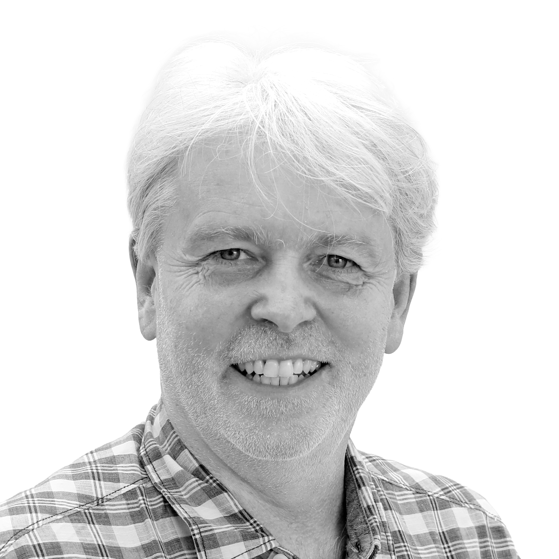 A smiling man with short white hair and a beard, wearing a plaid shirt, against a plain white background.