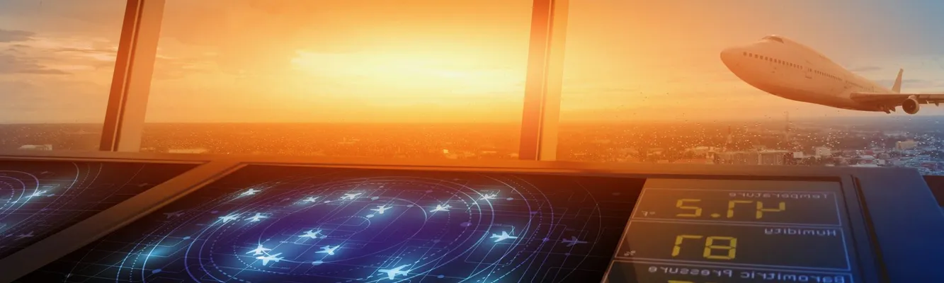 Air traffic control tower with radar screens, overlooking a sunset sky as a plane takes off in the distance.