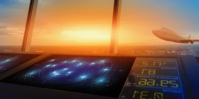 Air traffic control tower with radar screens, overlooking a sunset sky as a plane takes off in the distance.