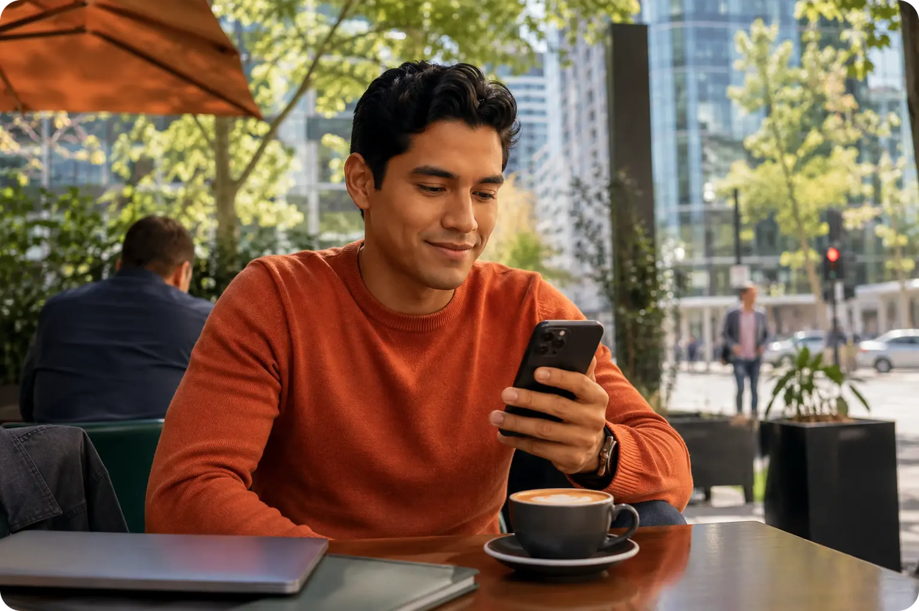 Young professional man sending money from Santiago, Chile on a mobile phone