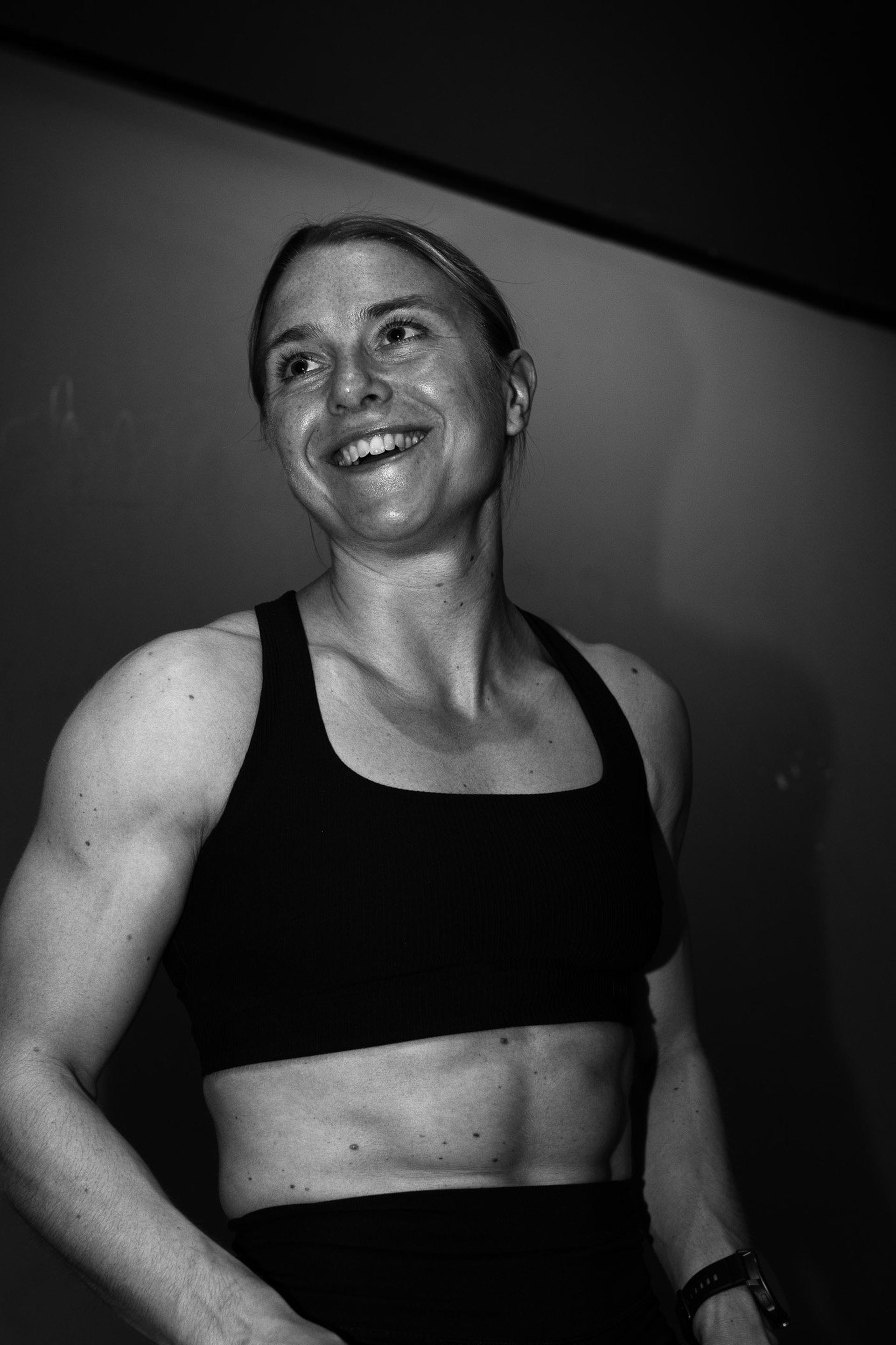 Smiling athlete in a black sports top in the gym
