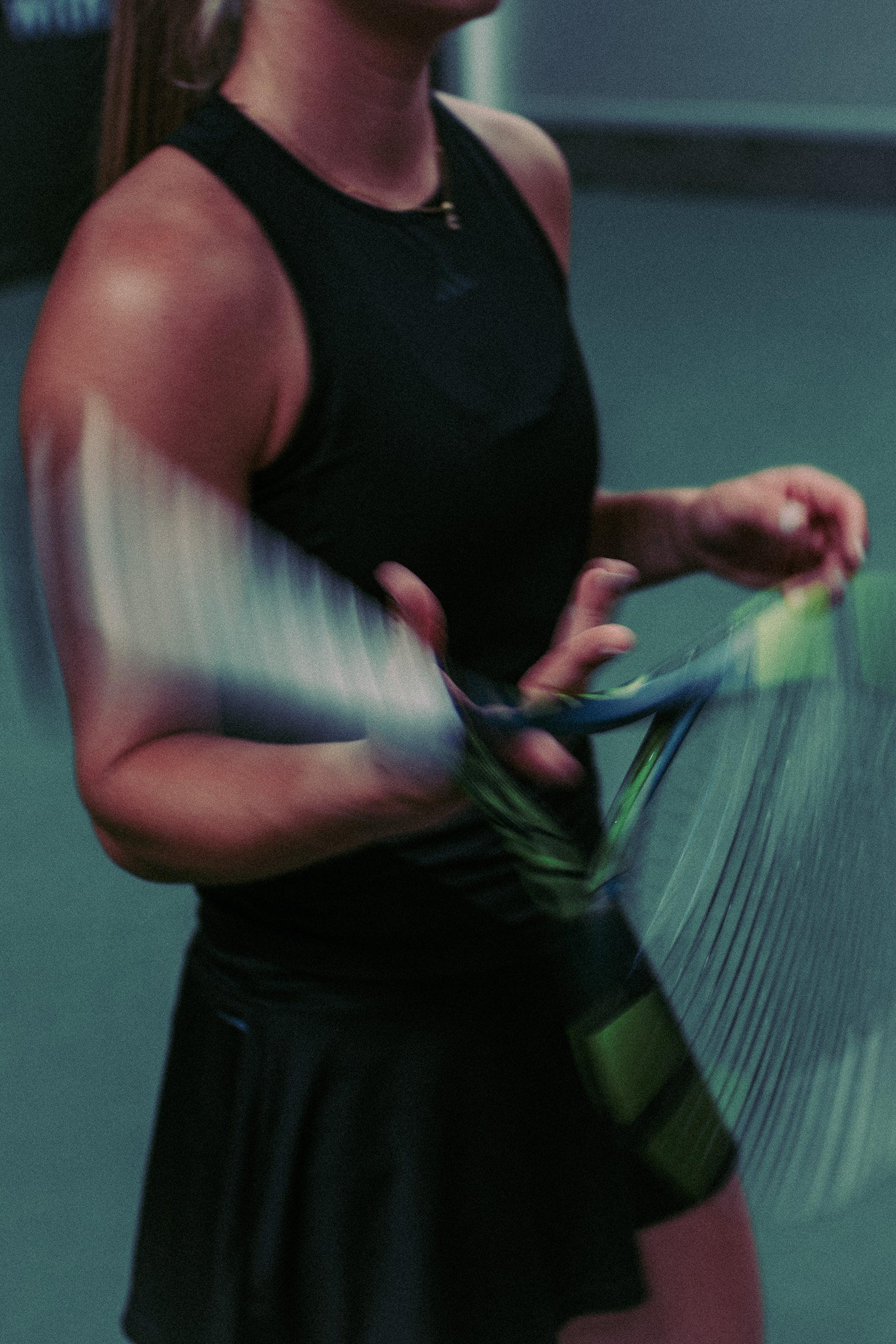Close-up of a tennis player holding her racket on court