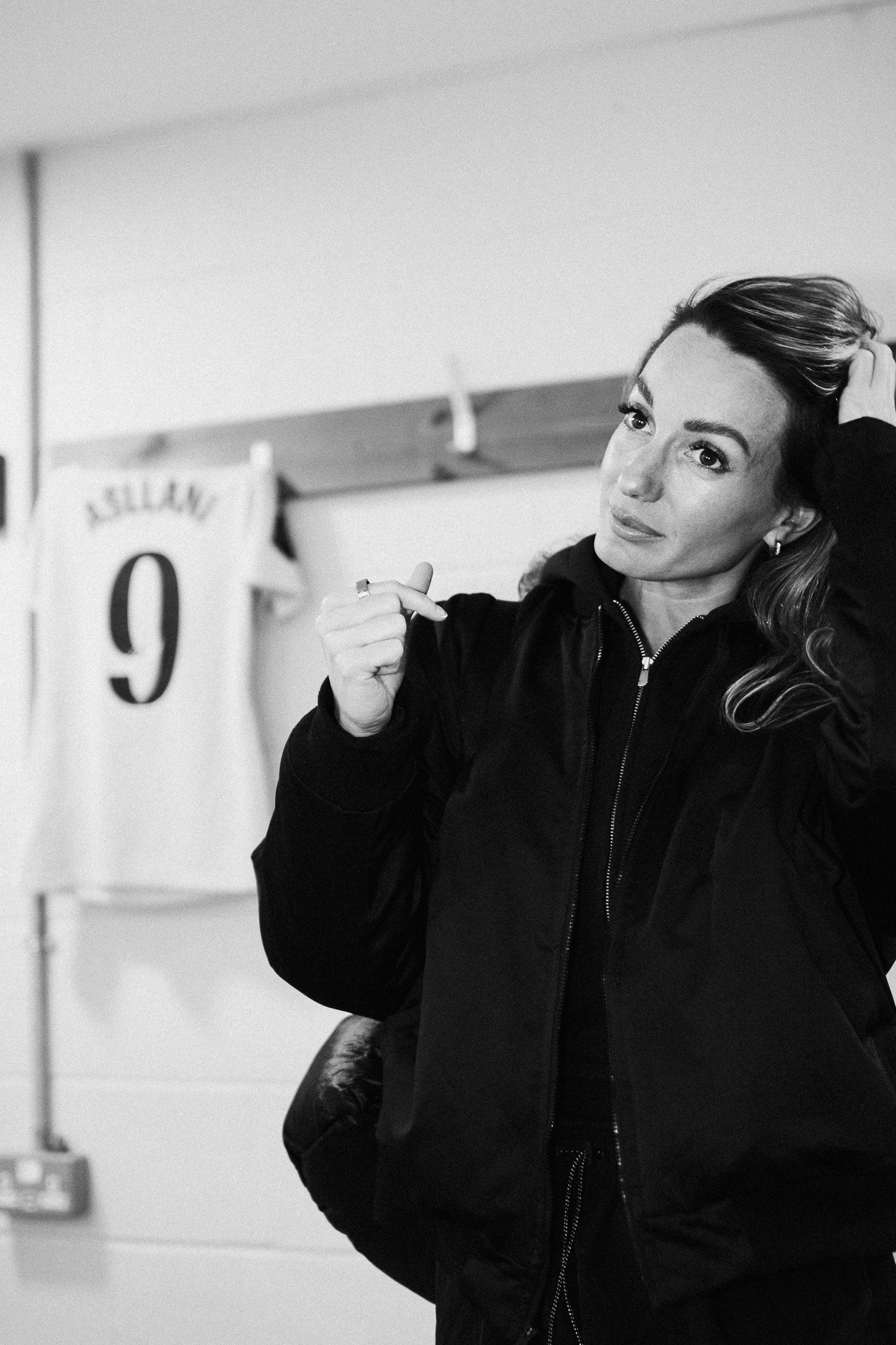 Footballer in a changing room in front of a number 9 shirt