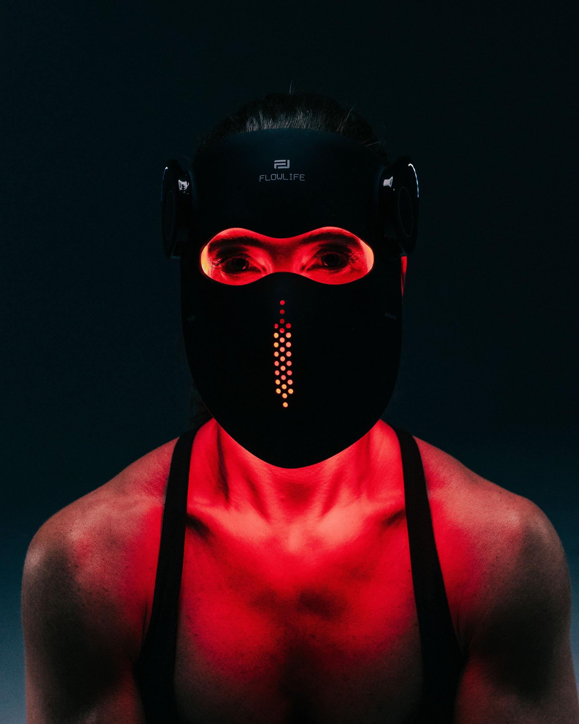 Woman wearing a Flowlight mask with red light glowing around the eyes