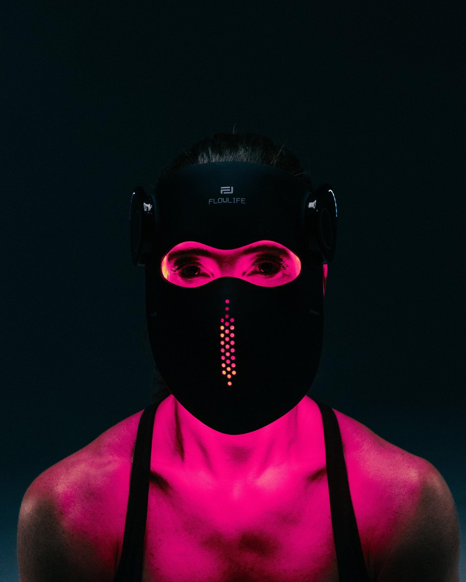 Woman wearing the Flowlight LED Mask Pro+ Three Waves with the light on