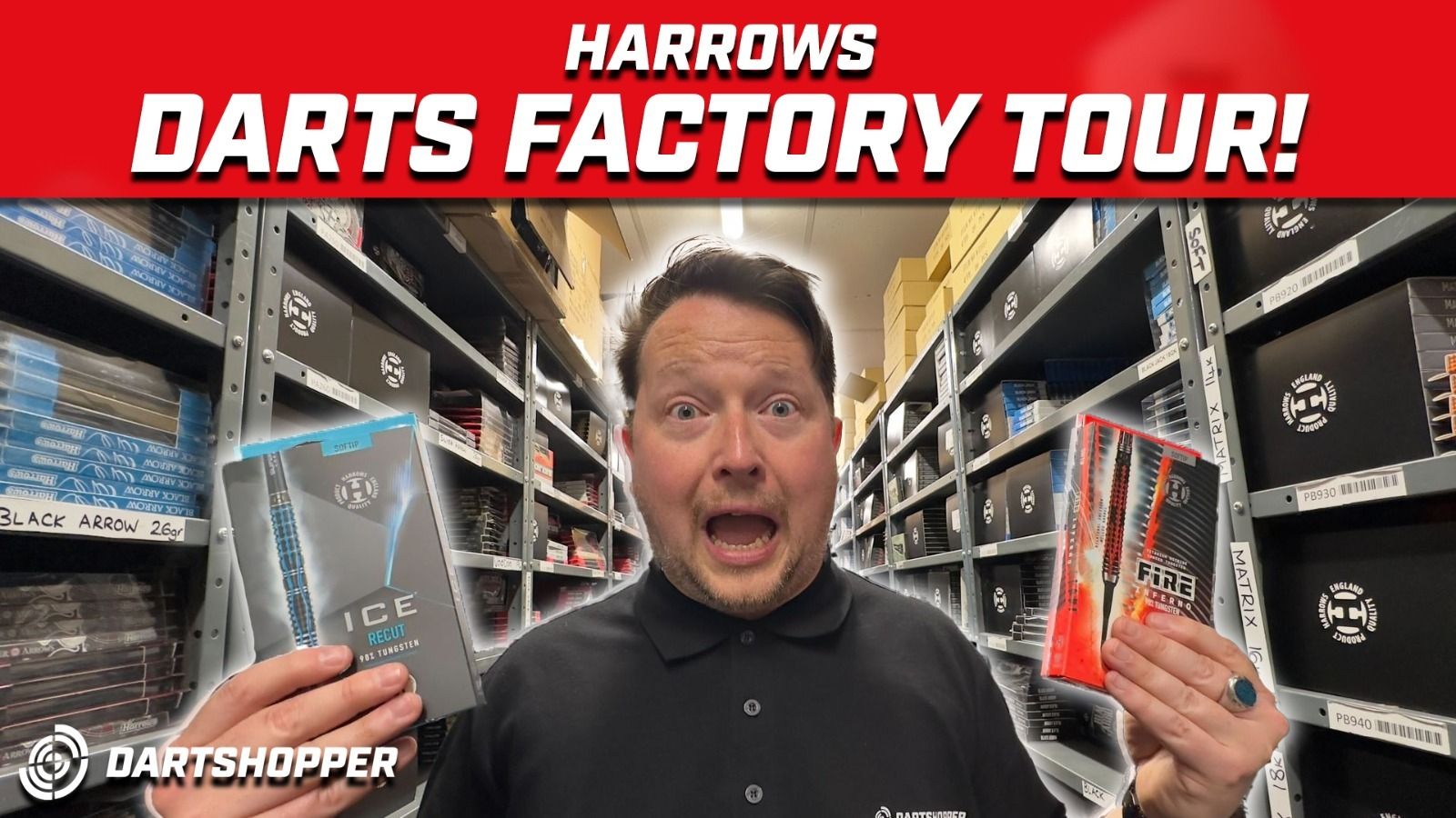 Person excitedly holding dart products in a warehouse aisle, with shelves of boxes and a "Harrows Darts Factory Tour" banner above.