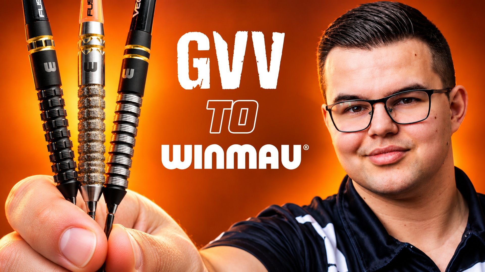 Man holding three darts in front of an orange background with the text "GVV to Winmau."