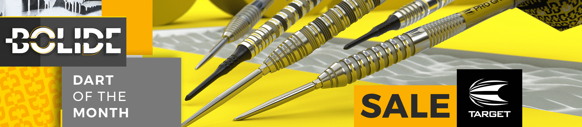 Close-up of Target Bolide darts with textured grips on a yellow and gray background. Text reads "Bolide Dart of the Month" and "Sale Target."
