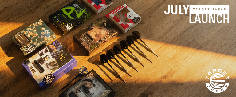 Dart boxes and darts arranged on a wooden surface with "July Launch Target Japan" text and Target Japan logo in the corner.