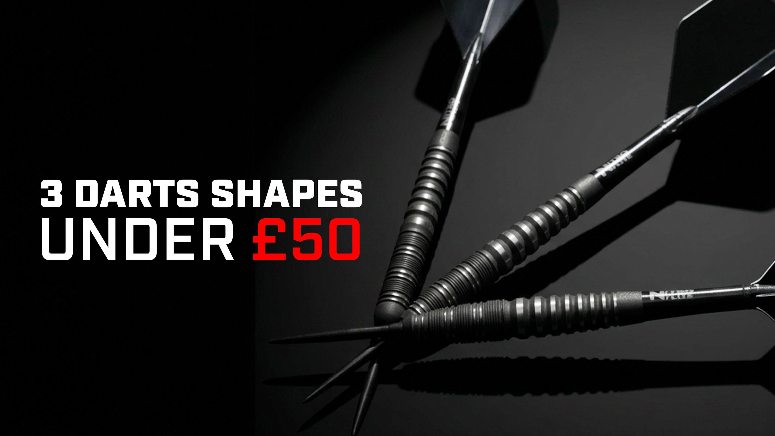 Three black darts with textured grips on a dark background. Text: "3 Darts Shapes Under £50."