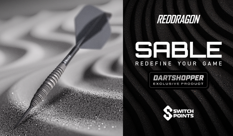 A dart embedded in textured sand next to promotional text for RedDragon Sable, highlighting it as a Dartshopper exclusive product with switch points.