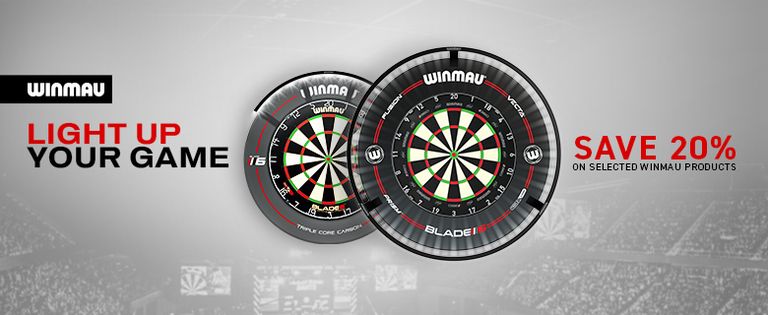 Winmau dartboards with promotional text "Light Up Your Game" and "Save 20% on selected Winmau products" against a blurred stadium backdrop.