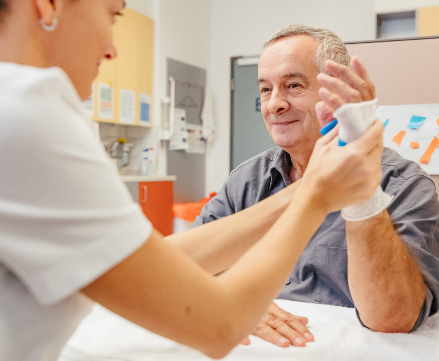 Ergotherapeutin legt angepasste Schiene nach einer Handoperation an. 