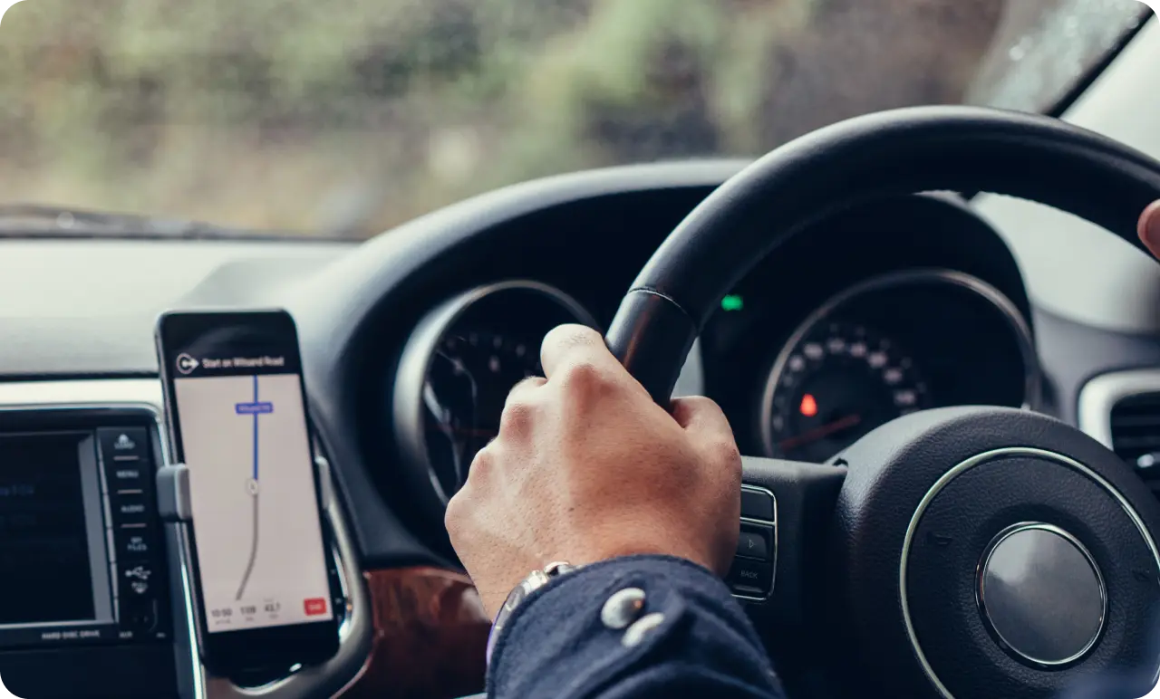 A driver following the map navigation in a rental car.