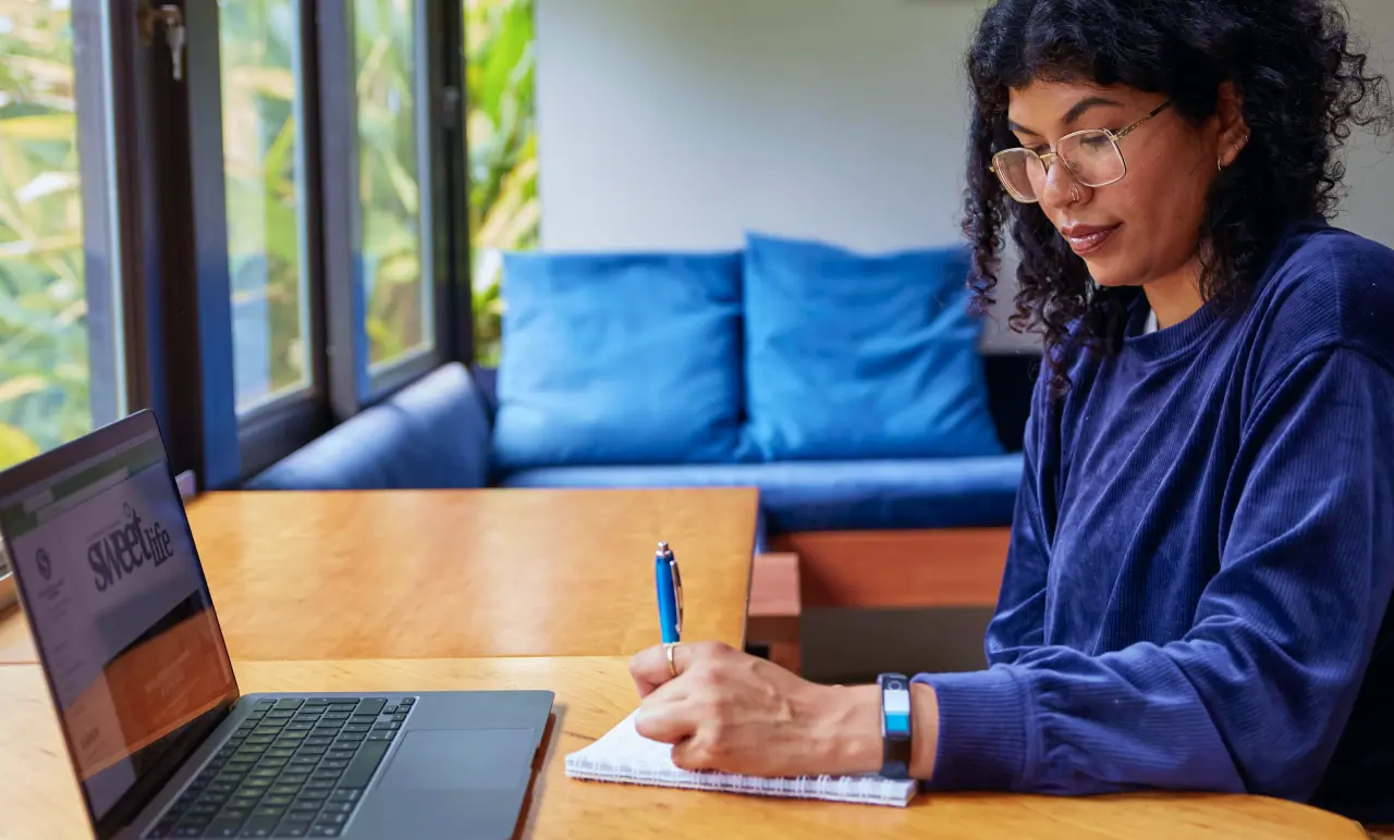 Woman Writing At Laptop
