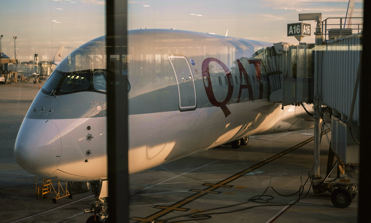 qatar airways jet outside an airport