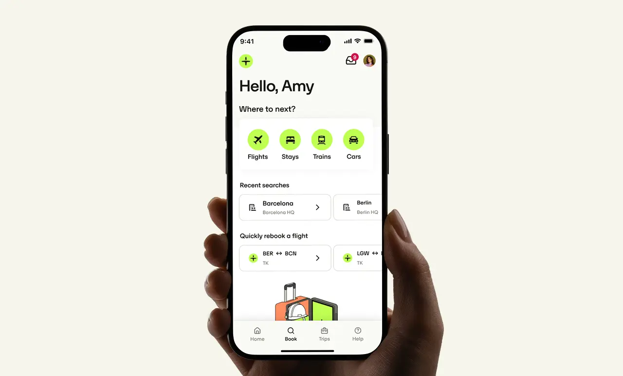 A hand holds a smartphone displaying the Perk travel app interface with options for flights, stays, trains, and cars, plus recent searches.