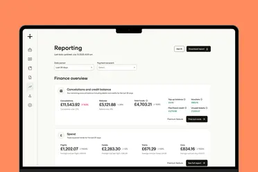 A laptop screen displaying a financial reporting dashboard with monetary figures under "Finance overview" and options to filter data and download reports.