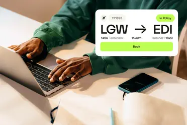 Person typing on a laptop with flight booking details overlayed, showing LGW to EDI, flight time 1h 30m, with a phone and notebook nearby.