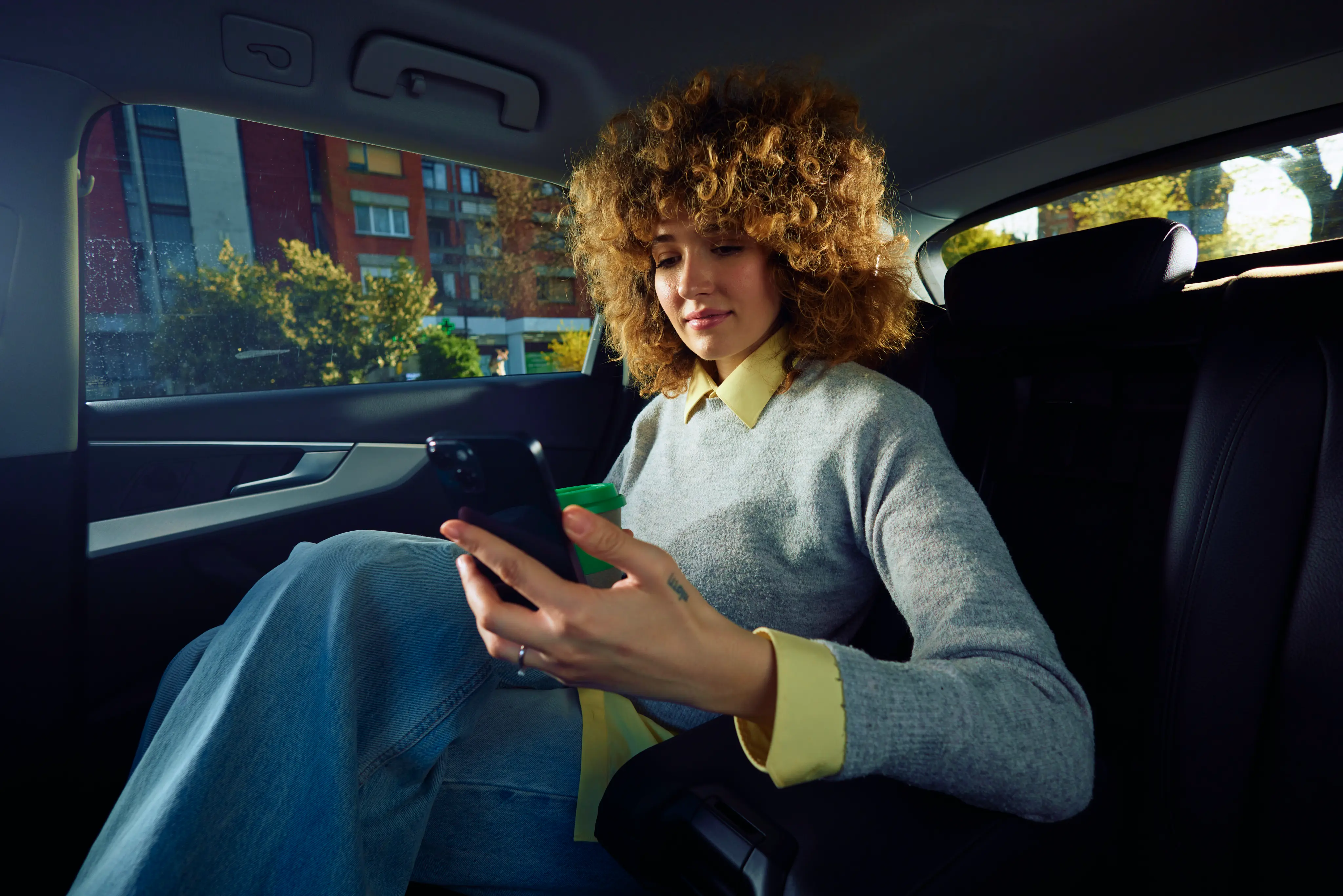Young Woman Rides In The Backseat Of The Car