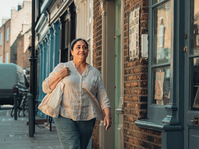 Adult walking briskly through London on a weekday morning.