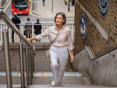 Adult walking briskly through London on a weekday morning.