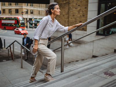Adult walking briskly through London on a weekday morning.