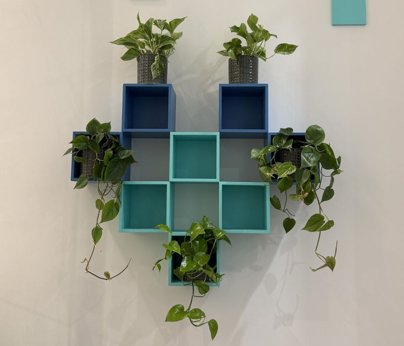 Heart-shaped plant shelves in brand colours at the LoveMyLife clinic
