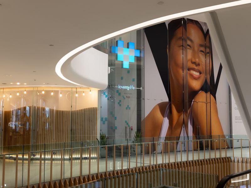 The LoveMyLife clinic and heart sign, straight ahead at the top of the escalators in The Village, Westfield London