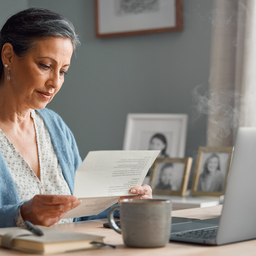 A patient at home reading a letter that links their NHS GP and a private specialist, organised at a desk