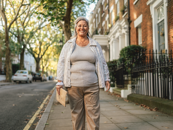 Woman walking home along a London street.
