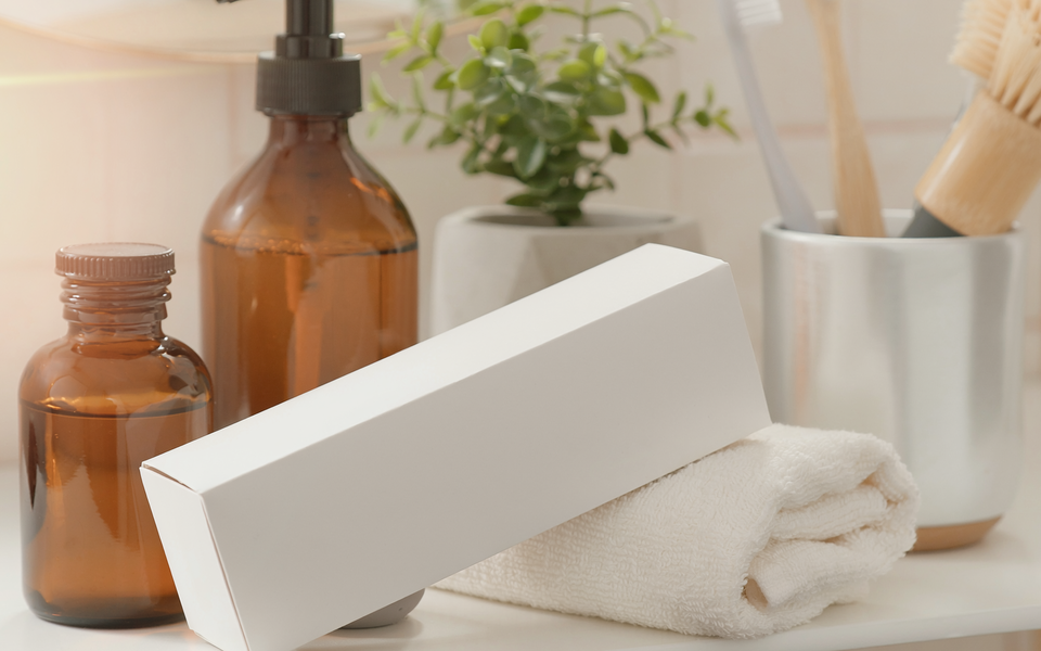 Plain unbranded test kit box on a bathroom shelf with a folded towel.