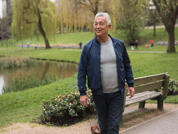 A man in his fifties on a relaxed daytime walk.