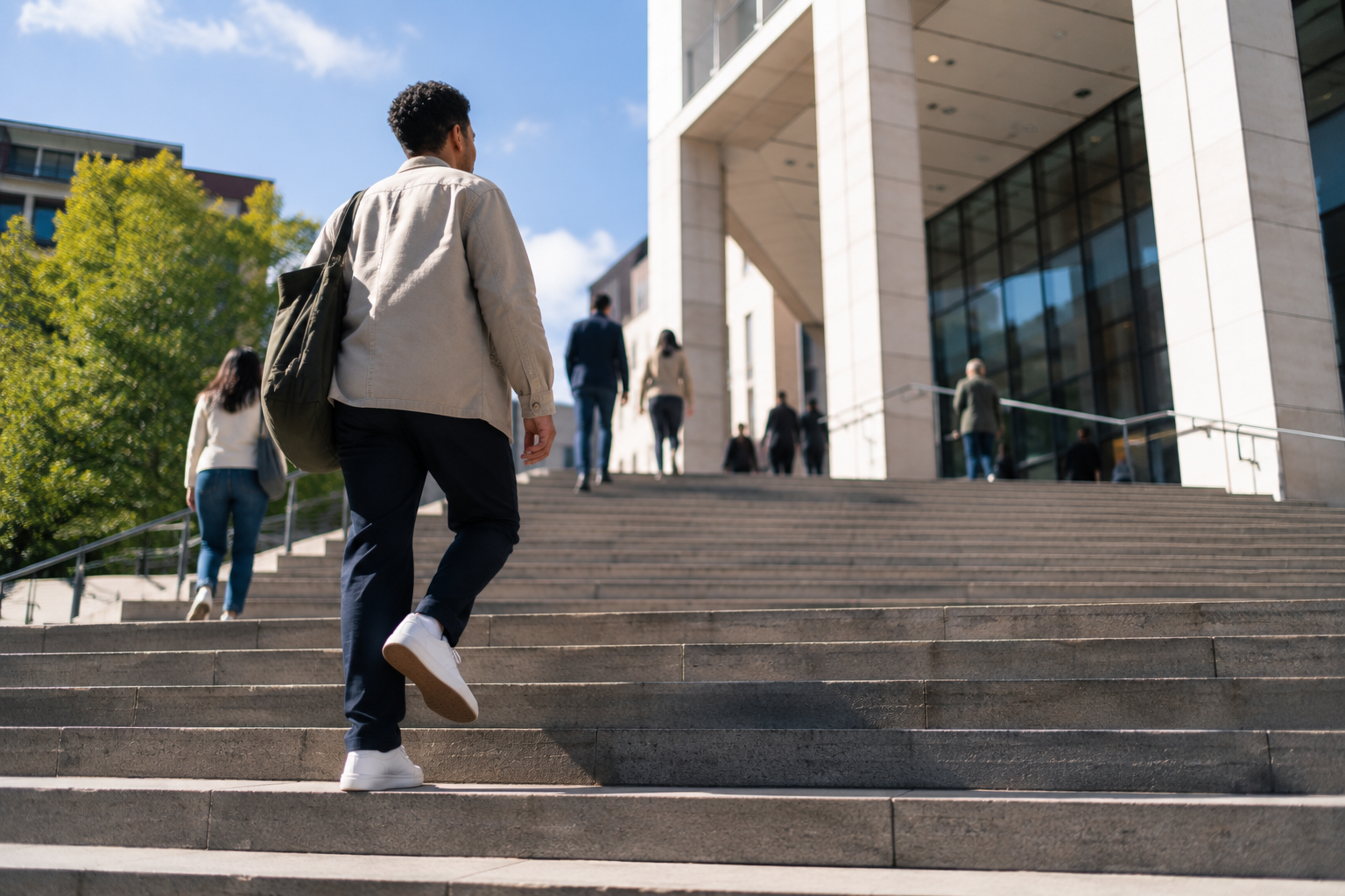 A person climbing the steps of a public health building.