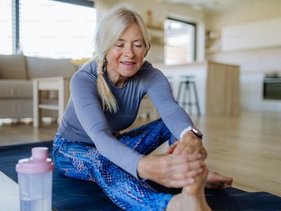 A fit woman in her fifties stretching