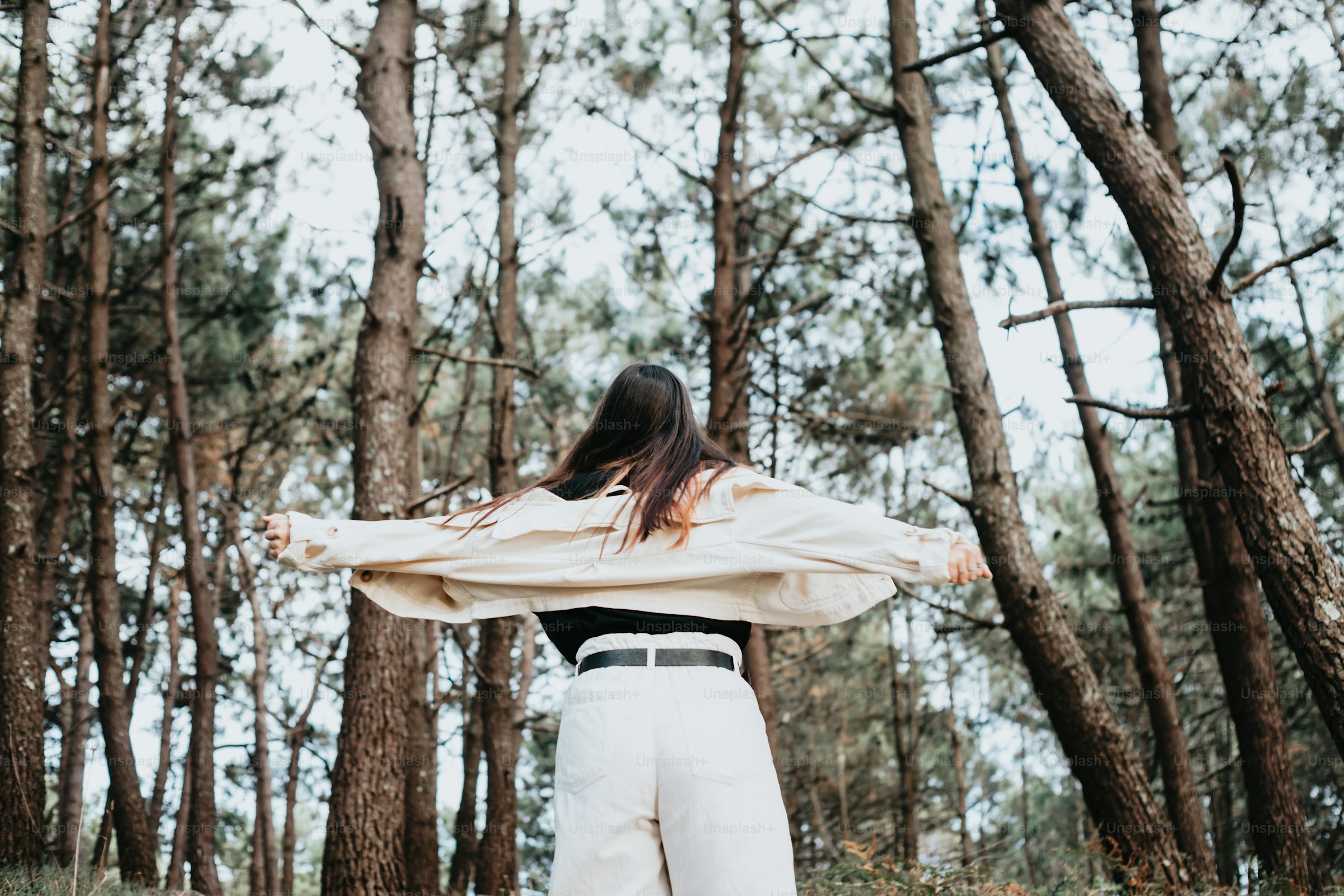 A woman standing confidently outdoors