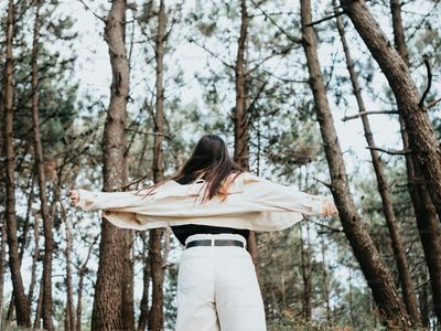 A woman standing confidently outdoors
