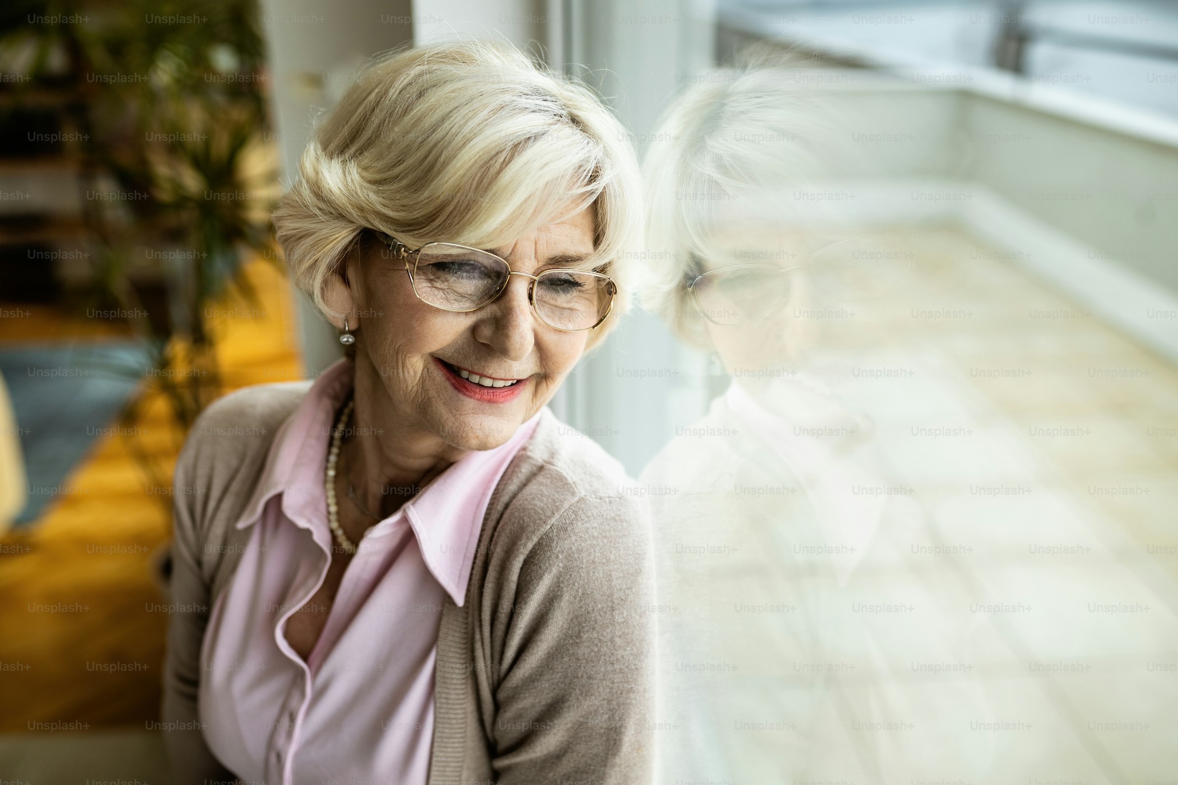 A mature woman sitting and reflecting at home