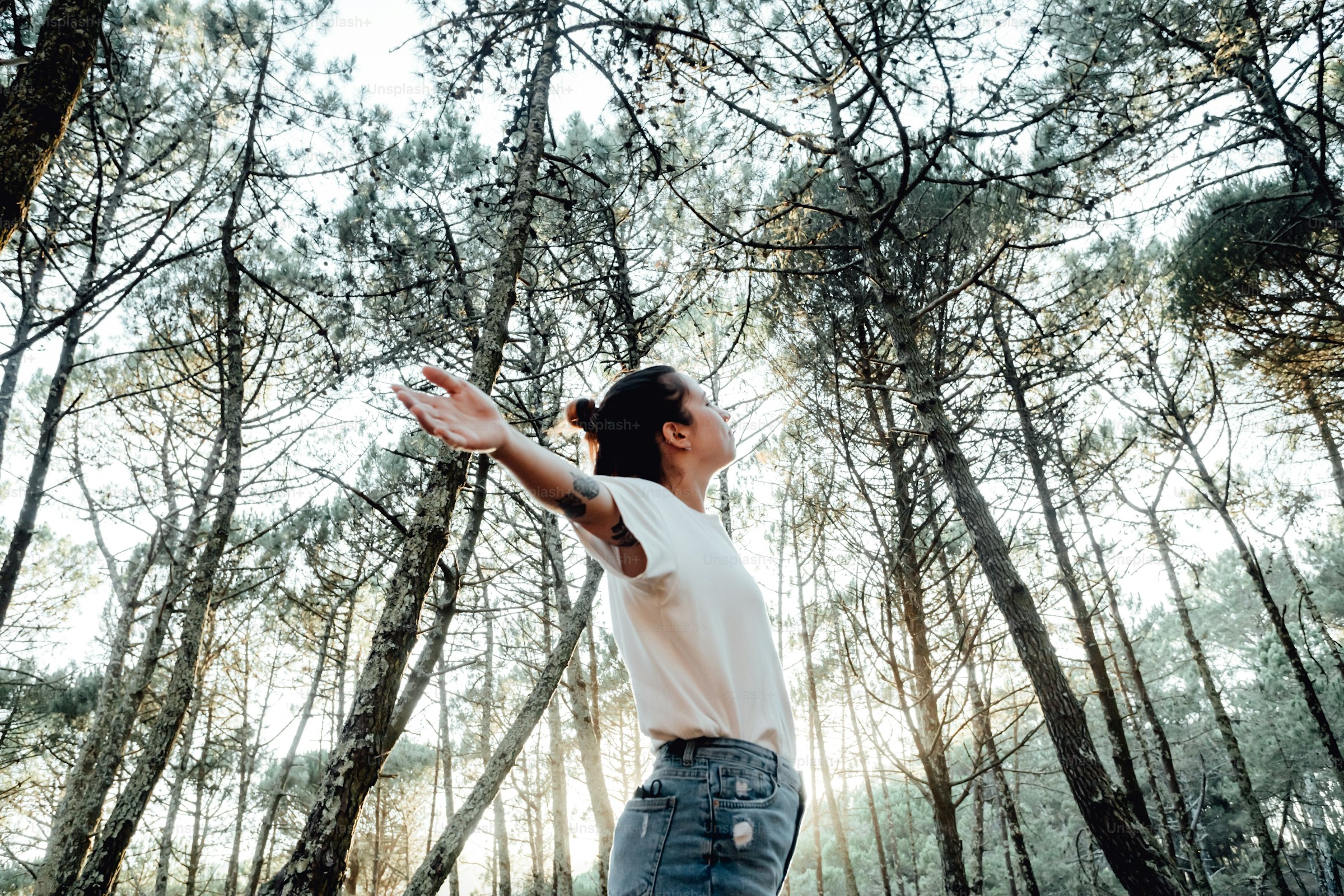 A woman standing among trees