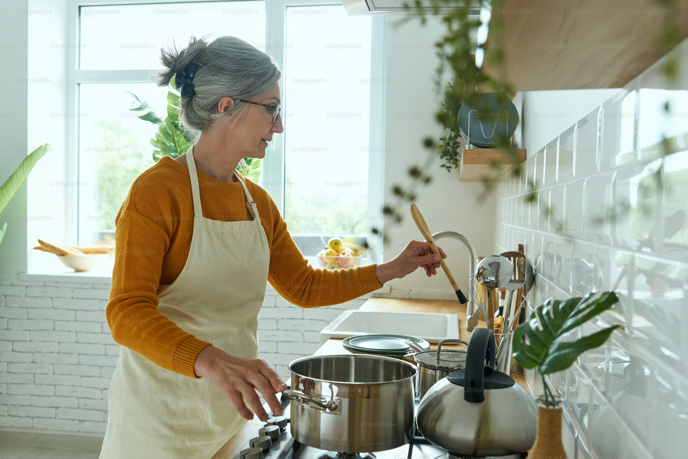 A confident woman cooking in her kitchen
